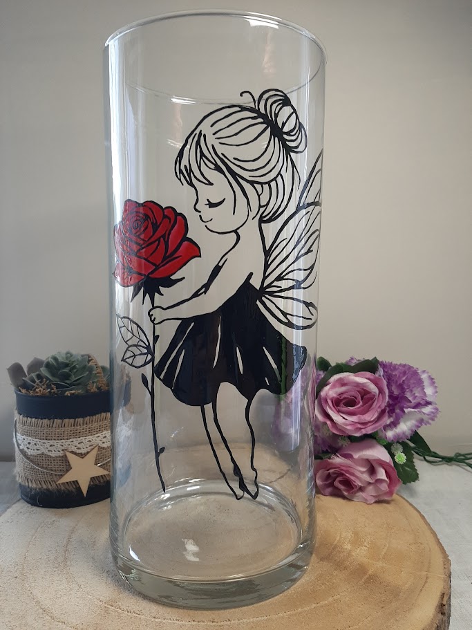 Grand vase cylindrique transparent avec une fée aux ailes délicates tenant une rose rouge éclatante, peint à la main, artisanat Aleco.