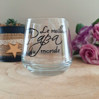 Verre à message peint à la main "Le meilleur Papa du monde", calligraphie noire, posé sur une table en bois avec des fleurs roses